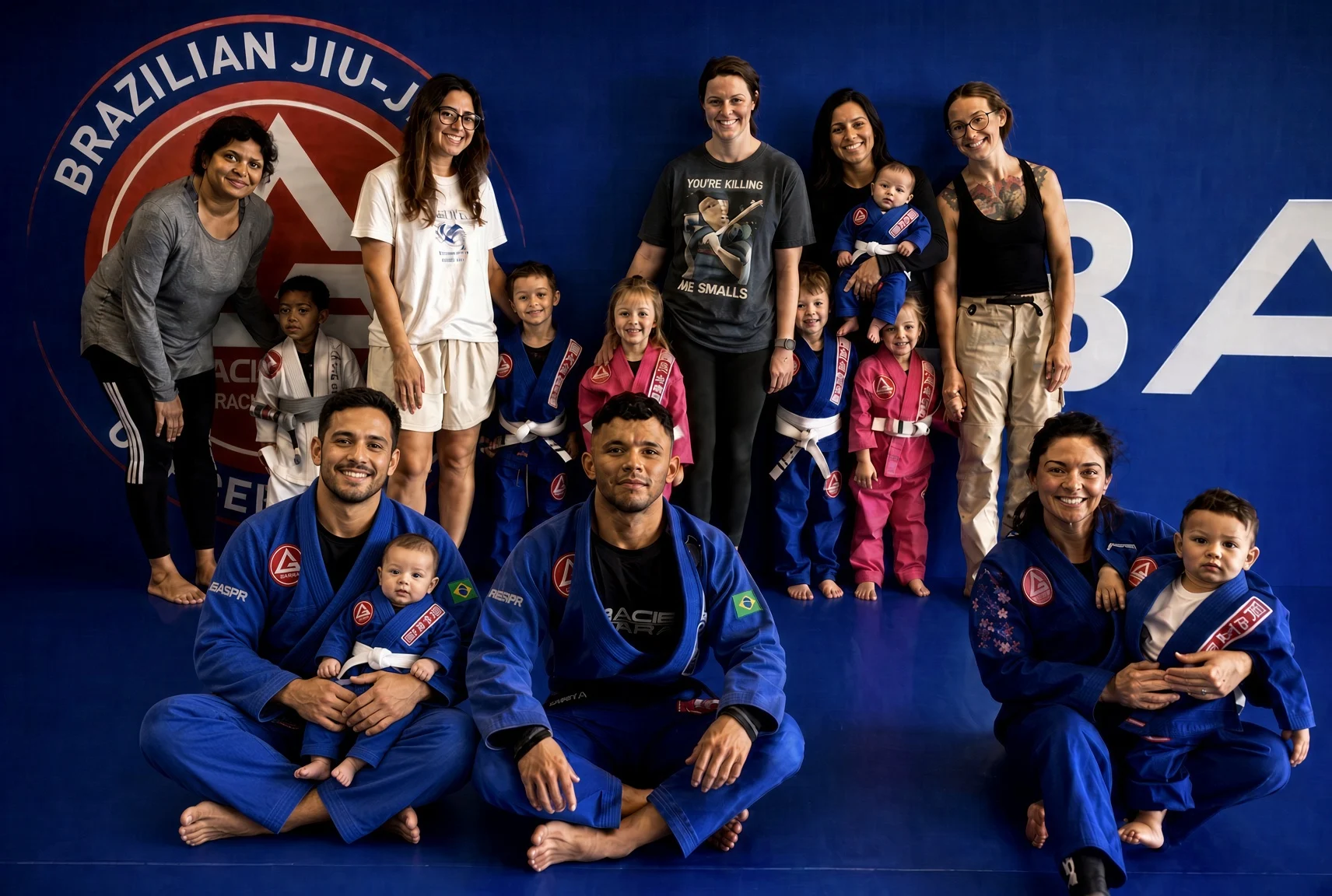 Gracie Barra Coppell families on the mat with a baby in a blue gi