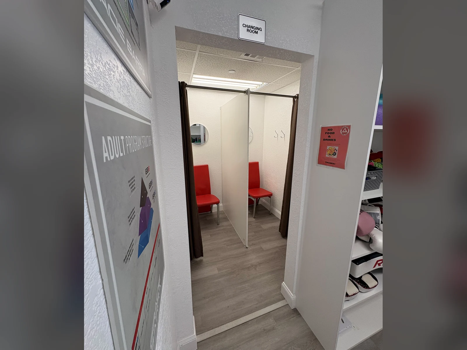 Changing Room entrance at Gracie Barra Coppell with private changing stalls and red chairs
