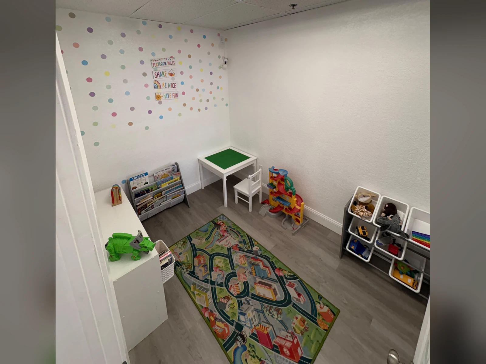 Kids Room at Gracie Barra Coppell with a play rug, toys, books, and a small table for siblings