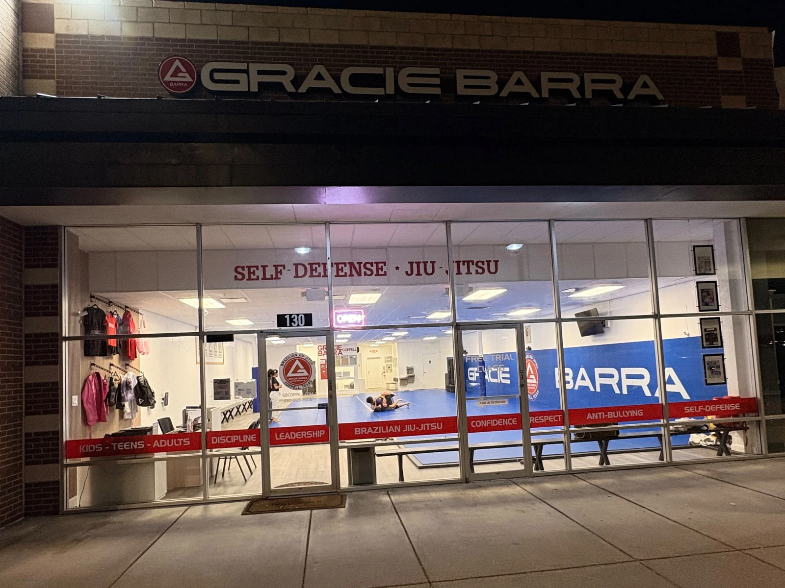 Gracie Barra Coppell storefront lit up at night